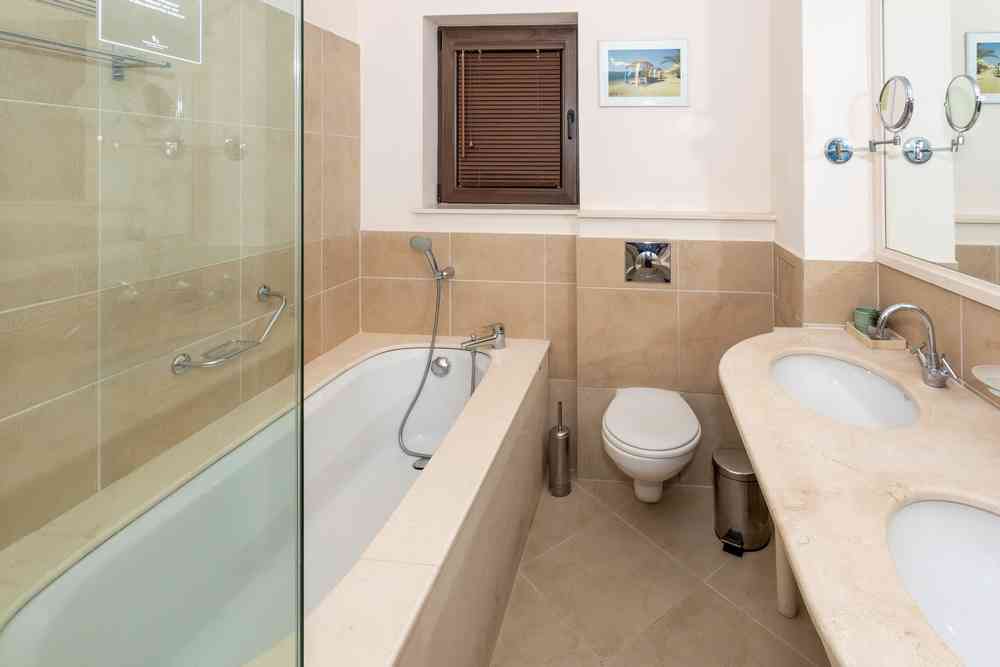 Main bathroom: bathtub, shower, and double vanity