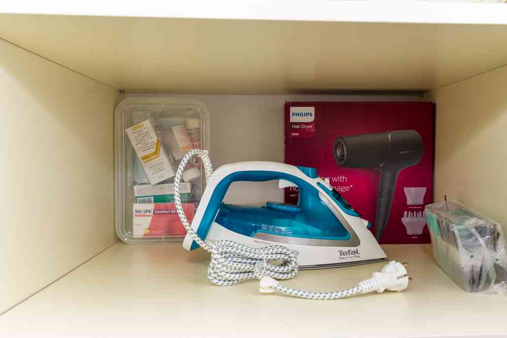 Iron, hair dryer, and first aid kit