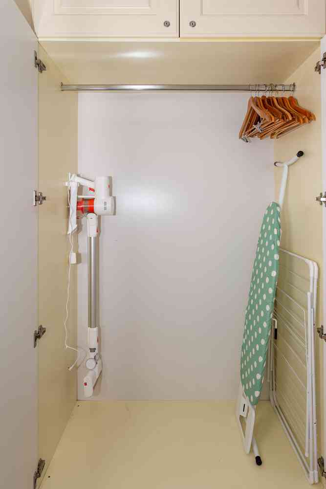 Closet with vacuum cleaner and ironing board