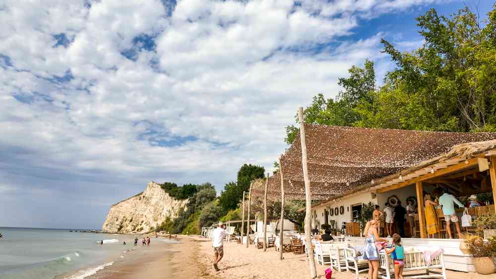 Beach bar with cliff backdrop